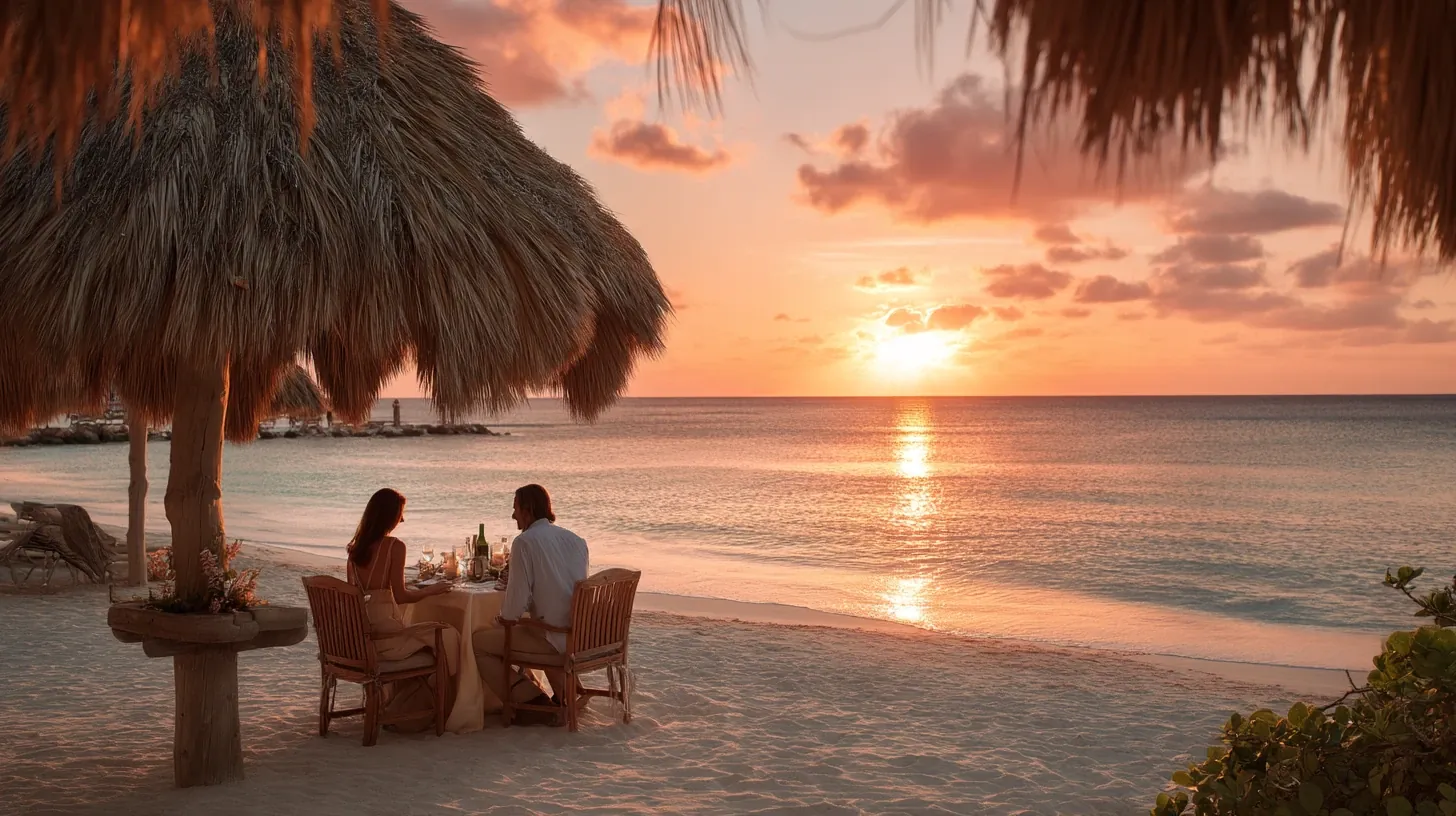 Couple enjoying private dinner by the sea at sunset in Aruba.